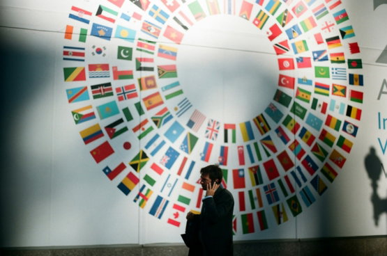 woman-in-black-coat-standing-near-round-white-red-and-blue-wall.jpg woman in black coat standing near round white red and blue wall